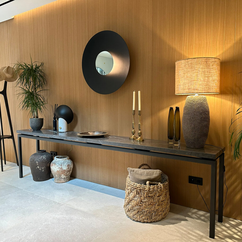 Bespoke console table with metal frame and natural stone top. Light & Living accessories with Aromas del Campo wall light.