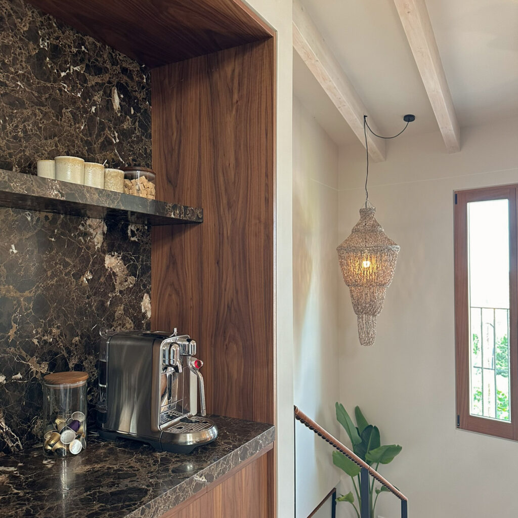 Bespoke walnut veneer coffee station / bar with emperador marble top and backsplash. Nesspresso coffee machine & pods in jar.