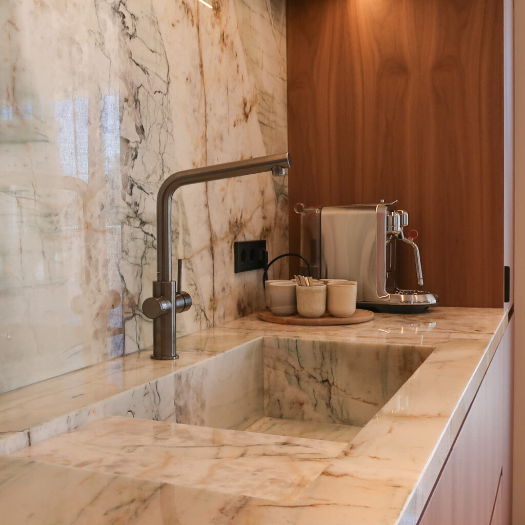 Bespoke kitchen design in walnut & quartzite worktops. Miele appliances.