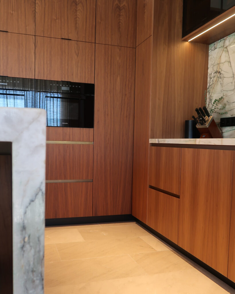 Bespoke kitchen design in walnut & quartzite worktops. Miele appliances. Antique brass detailing from Lost Cowboys in The Netherlands.