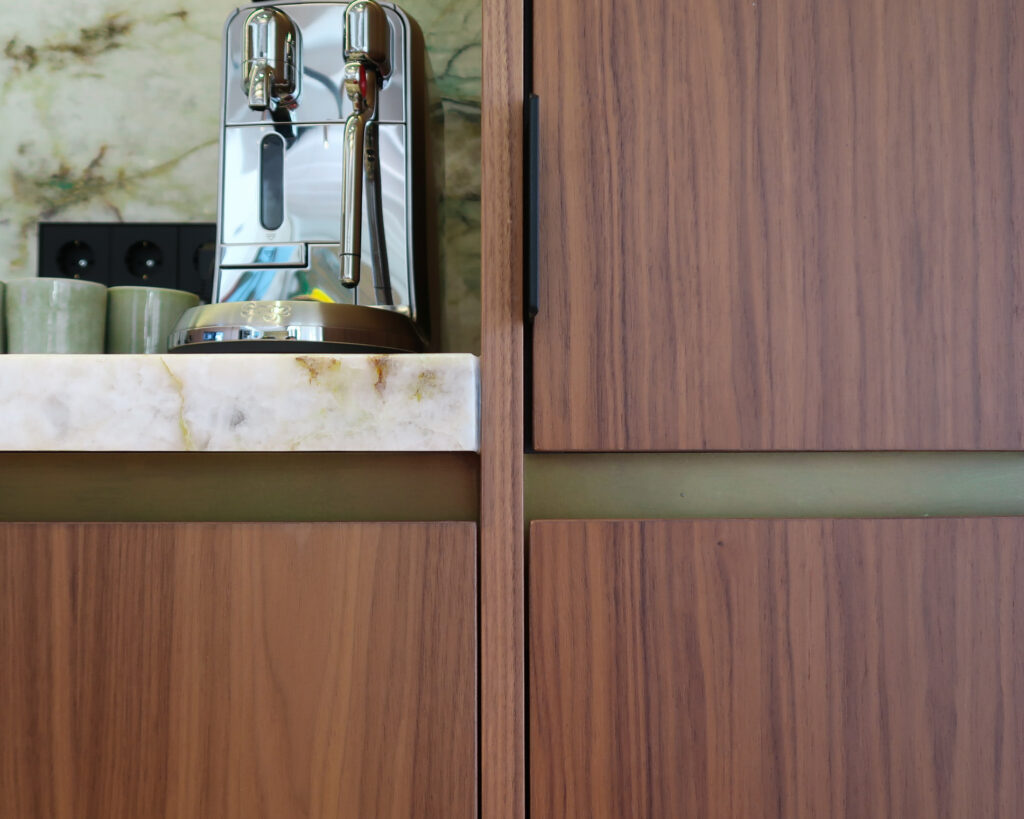 Bespoke kitchen design in walnut & quartzite worktops. Antique brass detailing from Lost Cowboys in The Netherlands.
